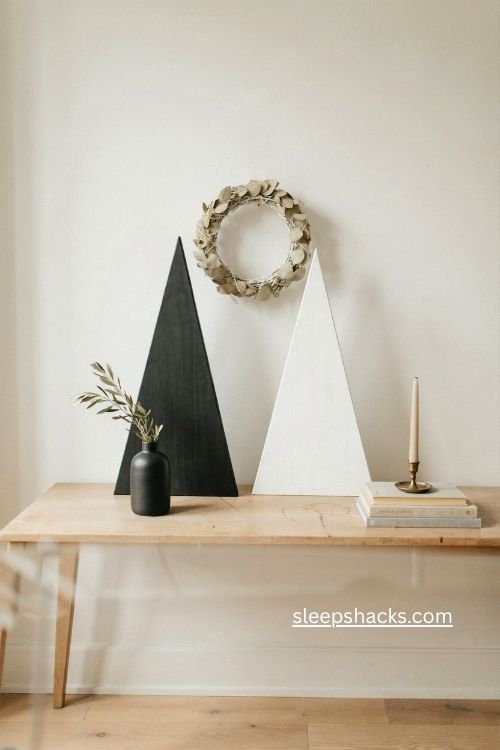 Modern black and white wooden Christmas trees on a console table