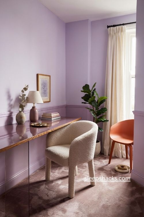 Monochrome purple home office with violet walls mauve trim and orange chair