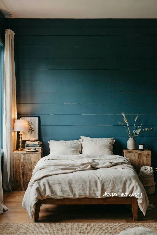 Moody teal bedroom colour ideas with shiplap accent wall wood furniture and brass details 