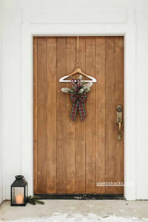 Neutral walnut and white Christmas door hanger with plaid bow and greenery