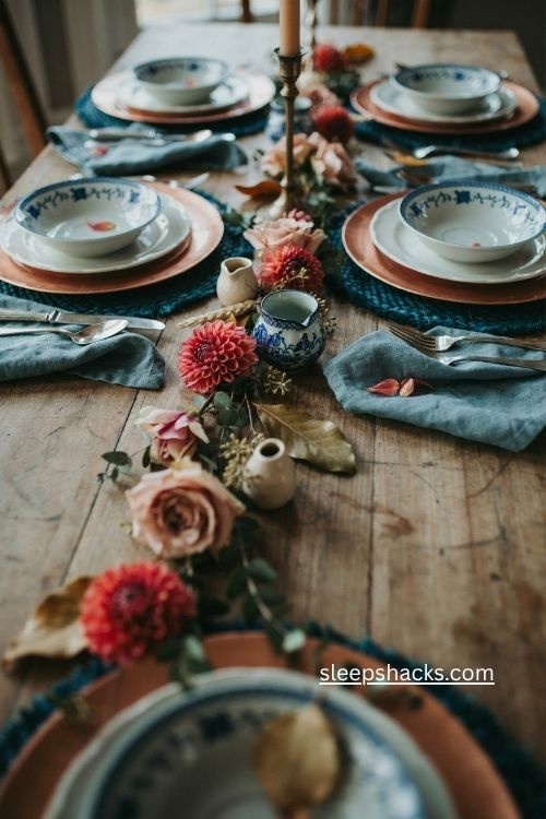 Painted rose gold chargers with blue willow plates for fall table decor