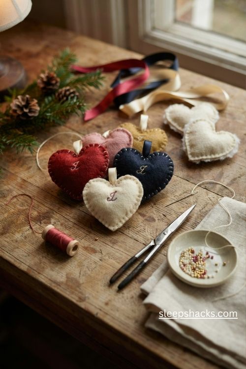 Personalized felt heart christmas ornaments with embroidered initials ribbon loops and delicate bead details