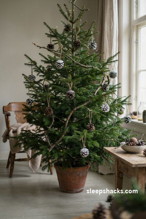 Pinecone and twig Christmas tree with snow-dusted natural ornaments and warm white lights