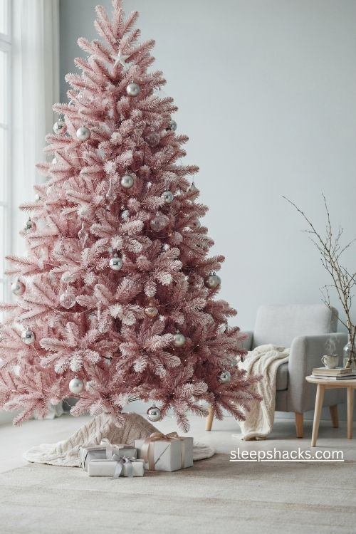 Pink flocked christmas tree with silver baubles clear glass ornaments and white stars
