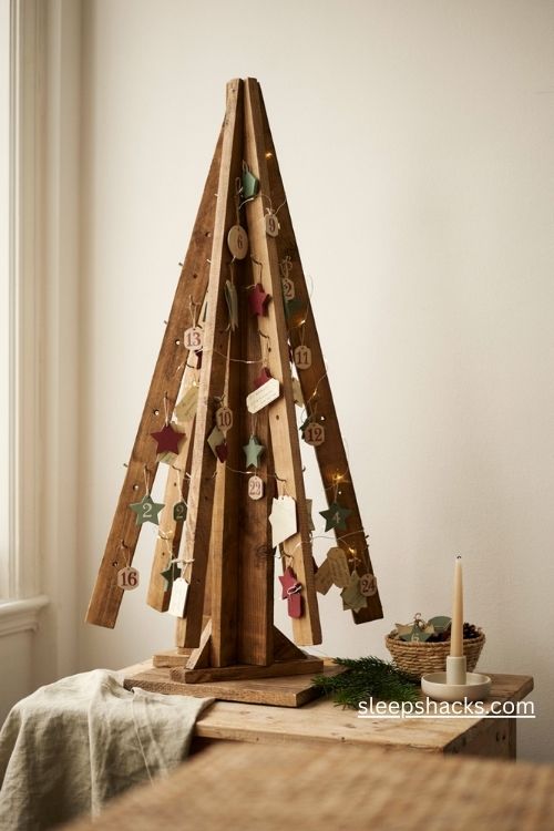 Reclaimed wood Christmas countdown tree with twenty four numbered pegs and handmade advent ornaments