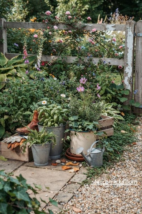 Recycled garden planters with vintage enamel pots galvanized buckets and rustic wooden crates
