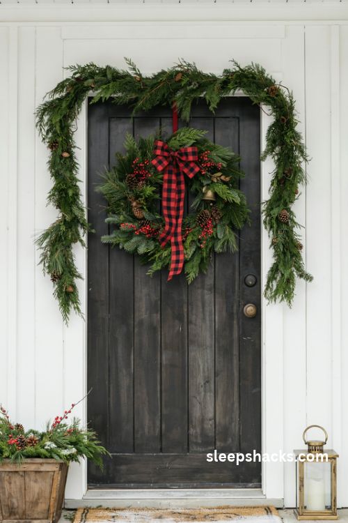 Red buffalo check plaid Christmas wreath with pinecones berries and brass bell on a farmhouse front door