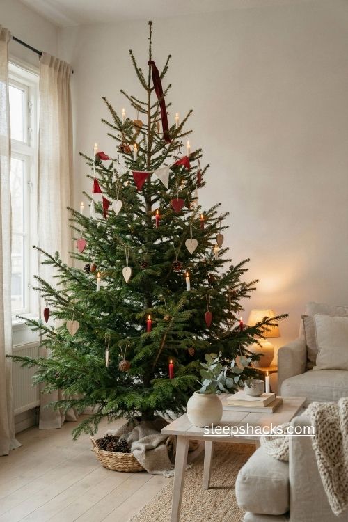 Red candle Nordic Christmas tree warm white lights Scandinavian decor 