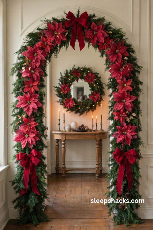 Red poinsettia Christmas arch with oversized velvet bows evergreen garland and gold accents