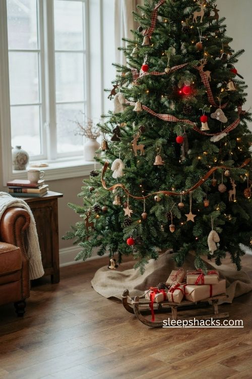Reindeer trail christmas tree with antler ornaments red noses plaid ribbon and brass bells