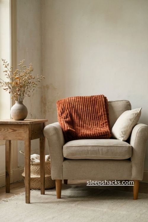 Ribbed rust blanket folded on armchair cozy fall texture