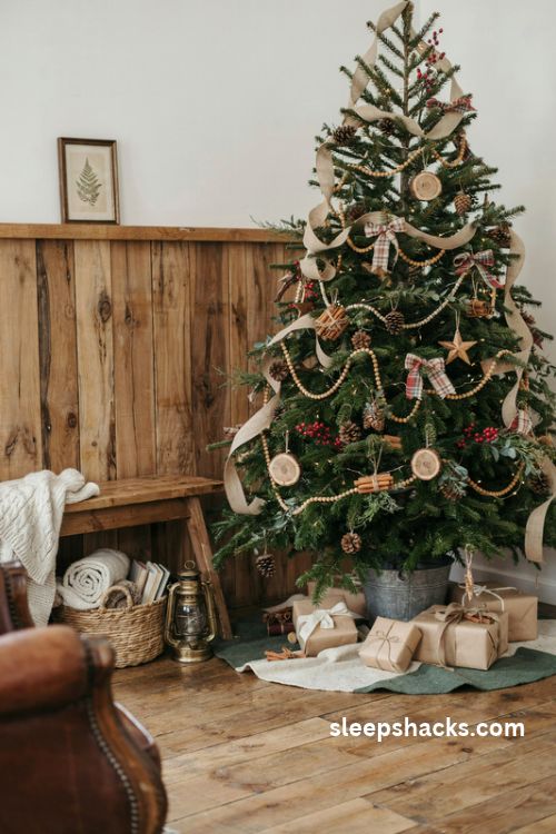 Rustic christmas tree with burlap ribbon wooden bead garlands and natural pinecone ornaments