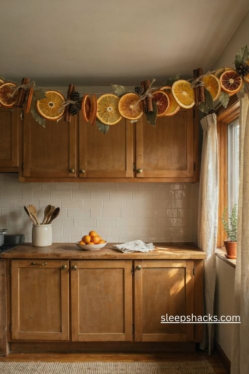 Rustic dried orange slice cinnamon stick and bay leaf christmas garland on wooden kitchen cabinets