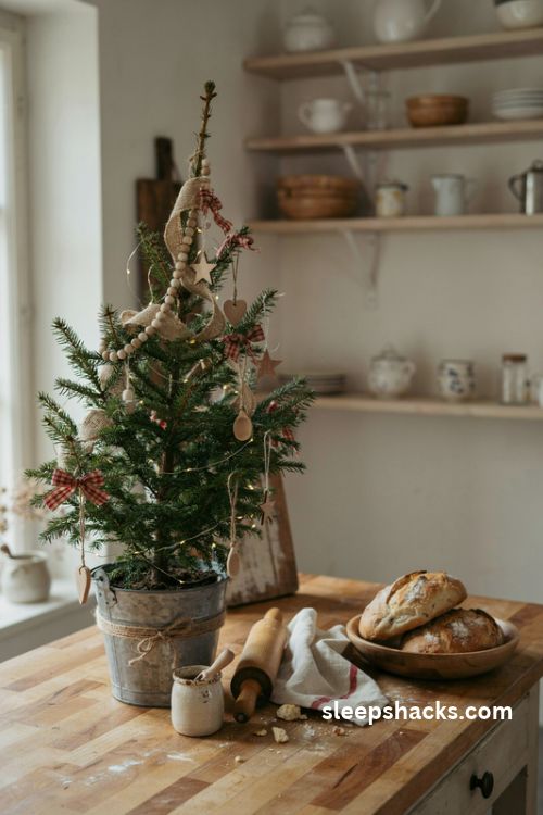 Rustic farmhouse Christmas tree with burlap ribbon and wooden ornaments in a cozy kitchen