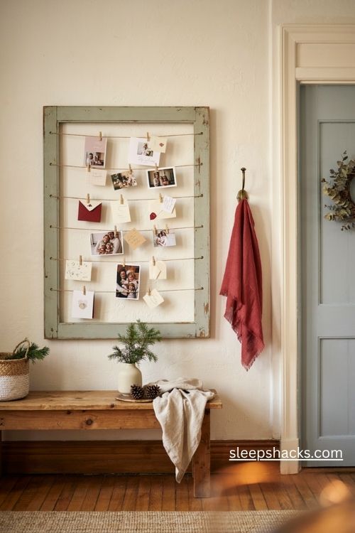 Rustic pallet wood Christmas card holder with twine and mini wooden pegs in a farmhouse entryway