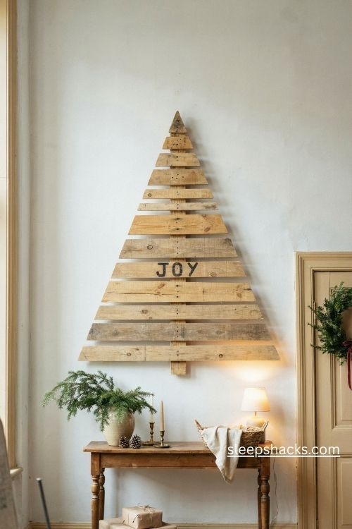Rustic pallet wood christmas tree with a meaningful holiday word on weathered boards in a farmhouse entryway 