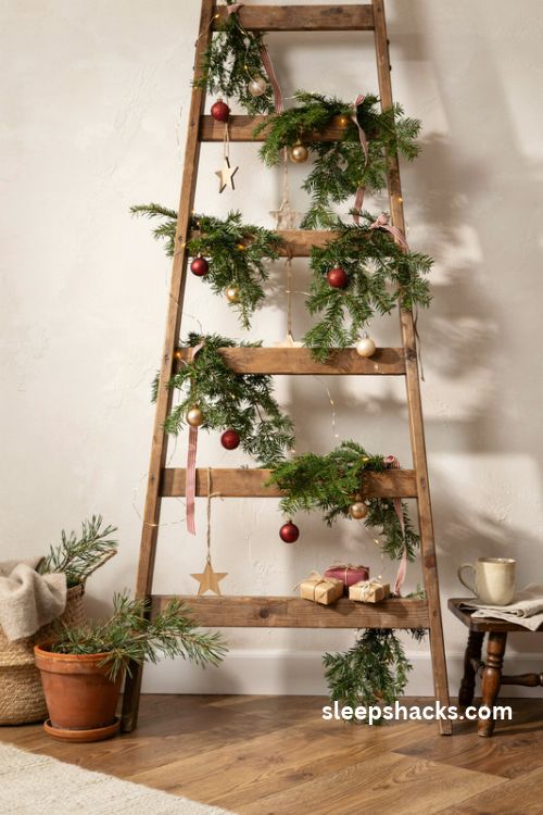 Rustic wooden ladder christmas tree with evergreen garland tiny gifts and warm fairy lights