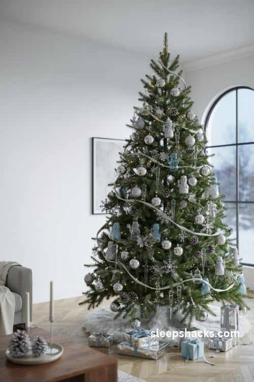 Silver and icy blue snowman Christmas tree with glitter ornaments and glass icicles
