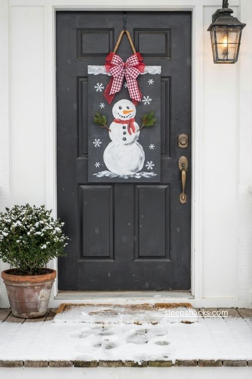 Snowman Christmas door hanger with buffalo check bow and evergreen trees