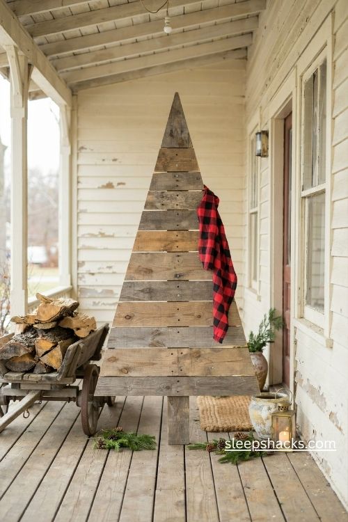 Solid reclaimed pallet wood christmas tree with plaid ribbon and rustic farmhouse porch decor 