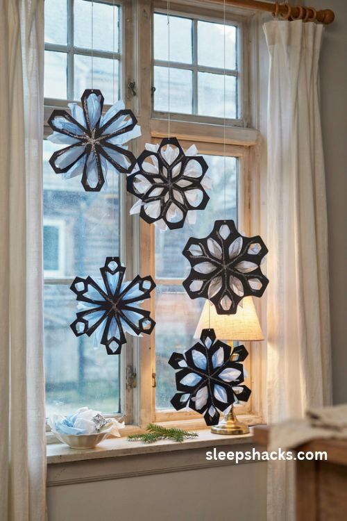 Stained glass Christmas snowflake hangings in pale blue silver and white tissue paper