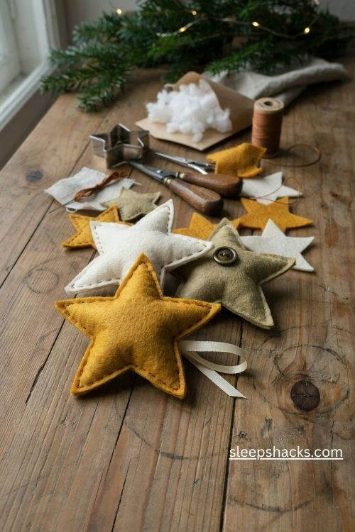 Stitched felt star christmas ornaments in mustard yellow cream and antique gold with button details
