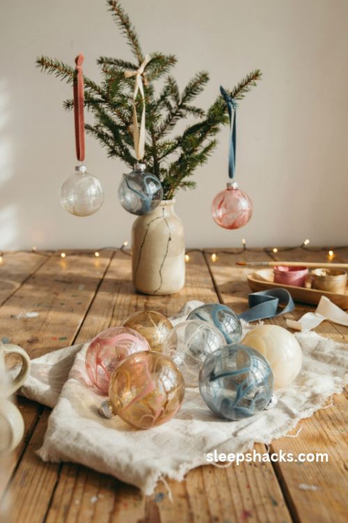 Swirl-painted glass christmas ornaments in blush pink and champagne gold