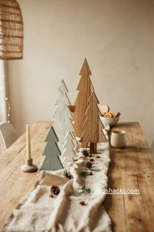 Tabletop cluster of mixed height wood christmas trees in natural white and sage green 