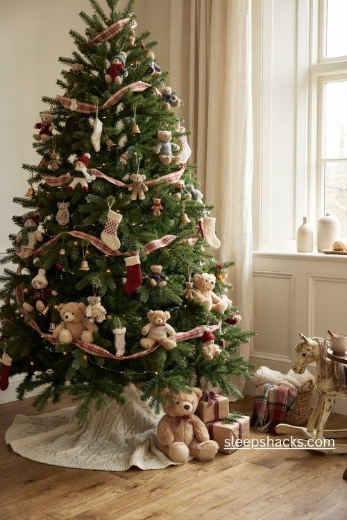 Teddy bear christmas tree with knitted sweaters plaid ribbon wooden ornaments and a chunky knit blanket