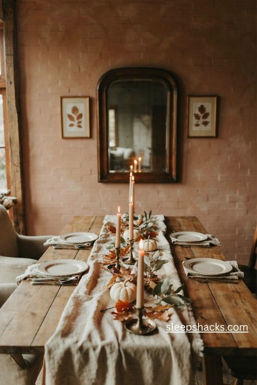 Thanksgiving wall decor with a warm brick orange accent wall rustic mirror and cozy farmhouse dining table 