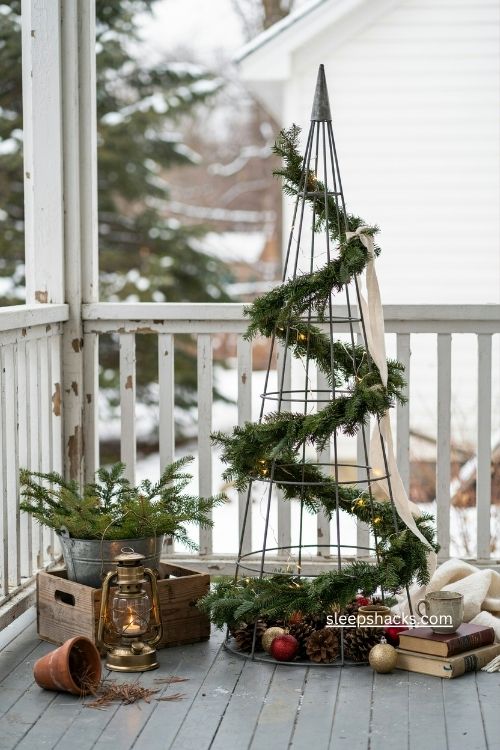 Tomato cage christmas tree with rustic garland and cozy farmhouse porch decor 