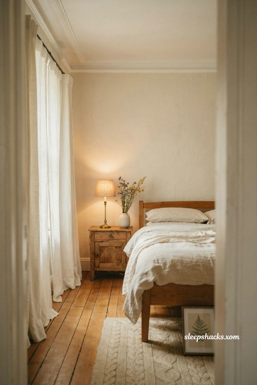 Warm cream bedroom walls paired with soft white trim and cozy golden lighting