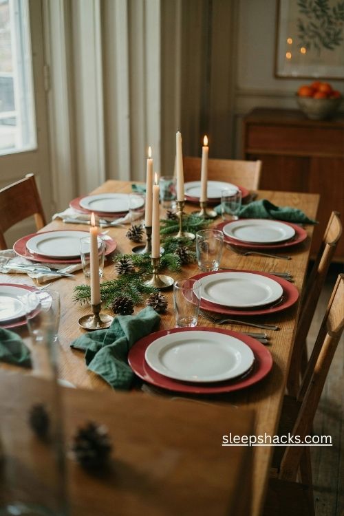 White christmas dinner plates on red chargers with green napkins and festive table decor