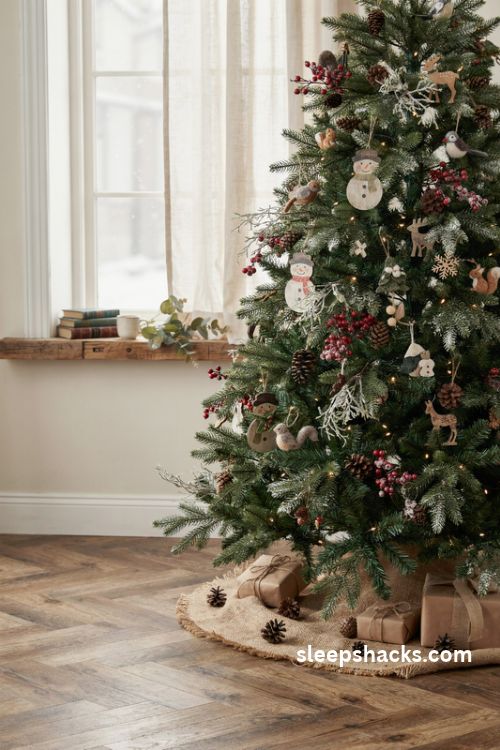Woodland snowman Christmas tree with faux snow pinecones red berries and rustic ornaments