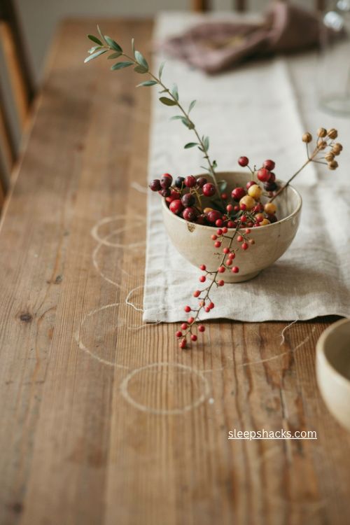deep red plum and gold berry stems in a small bowl simple fall table centerpiece 