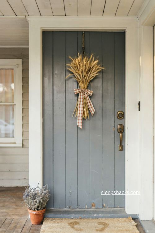 fall door decor with golden wheat bundle and rustic plaid ribbon 