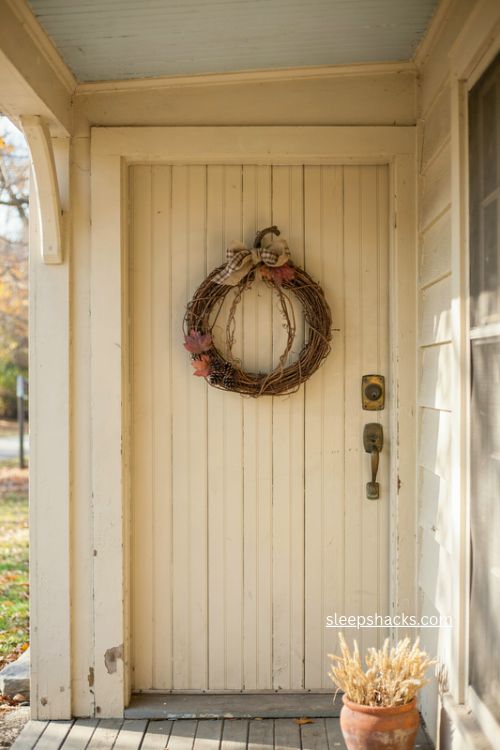 fall door decor with grapevine pumpkin leaves pinecones and burlap bow 