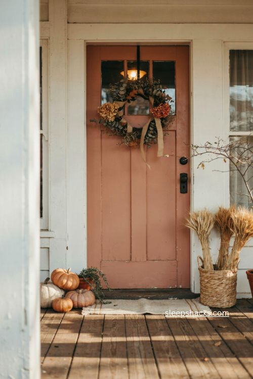fall door decor with layered wreath basket pumpkins and wheat porch styling