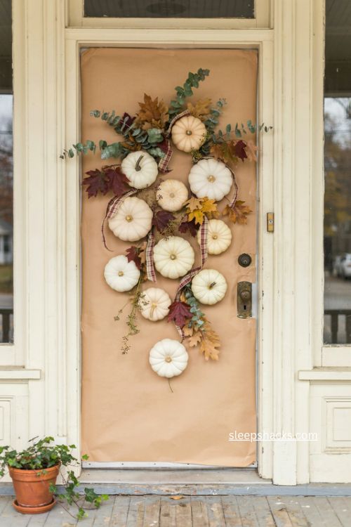 fall door decor with white pumpkin parade kraft paper and plaid ribbon 