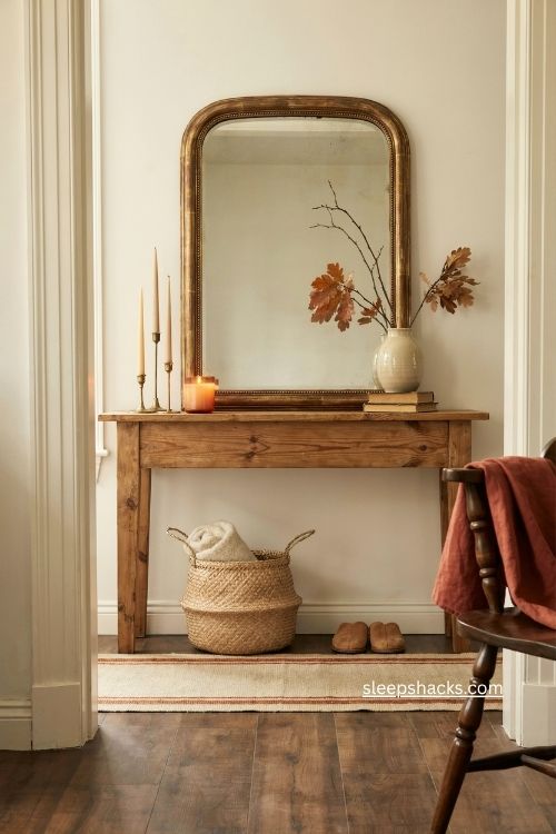 fall entry table decor with gold candlesticks and vanilla amber candle 