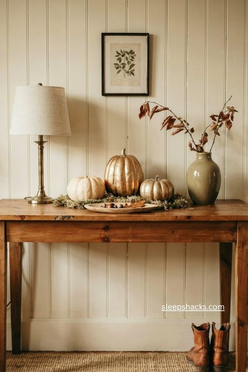 fall entry table decor with gold pumpkins and cream accents 