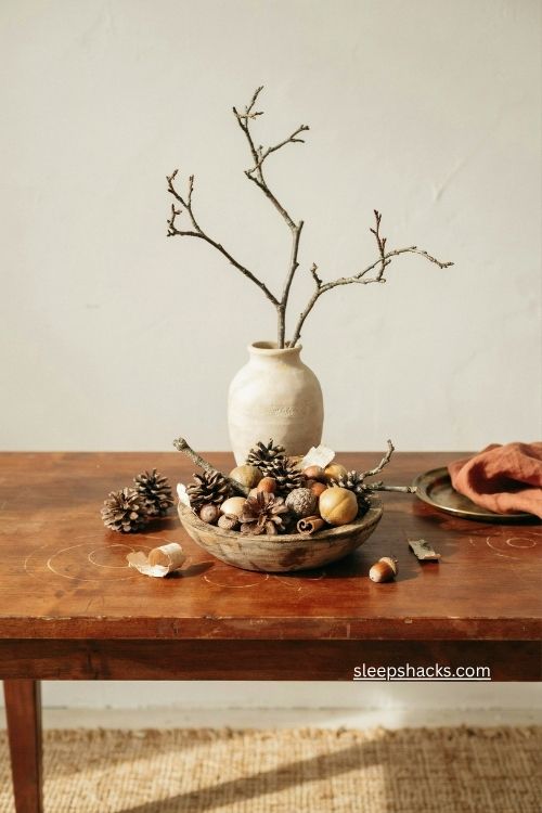 fall entry table decor with pinecones acorns twigs and birch bark 