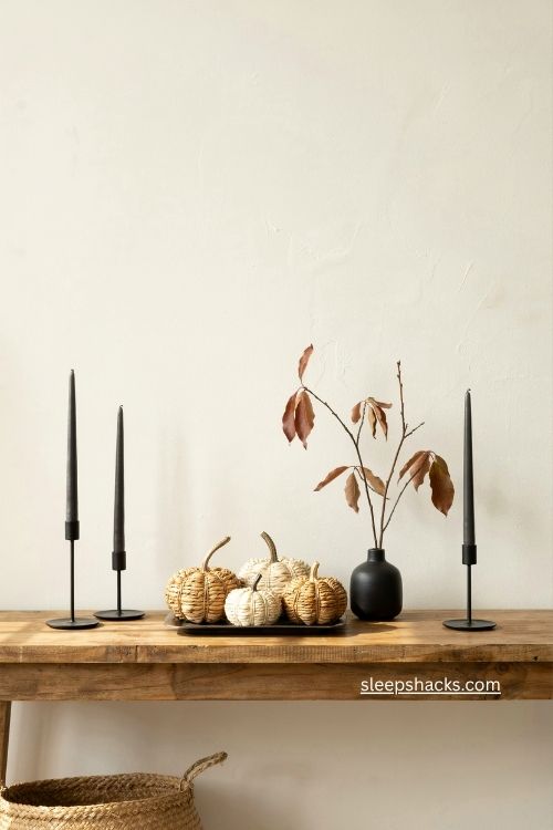 fall entry table decor with woven pumpkins and black accents 