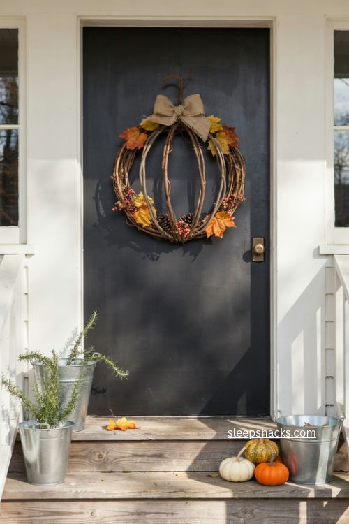 grapevine pumpkin fall door decor with leaves berries pinecones and burlap bow 