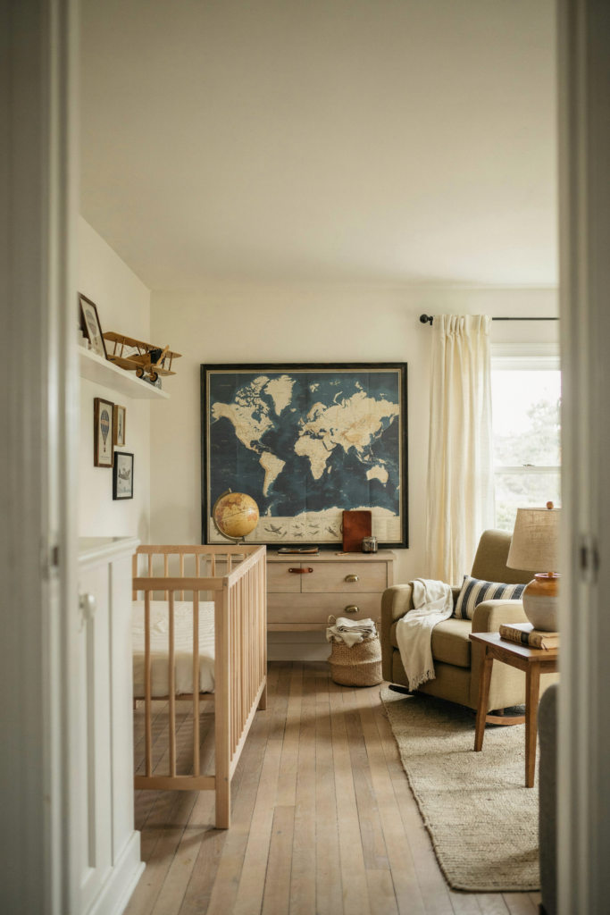Baby boy nursery with vintage world map airplane decor navy and cream accents