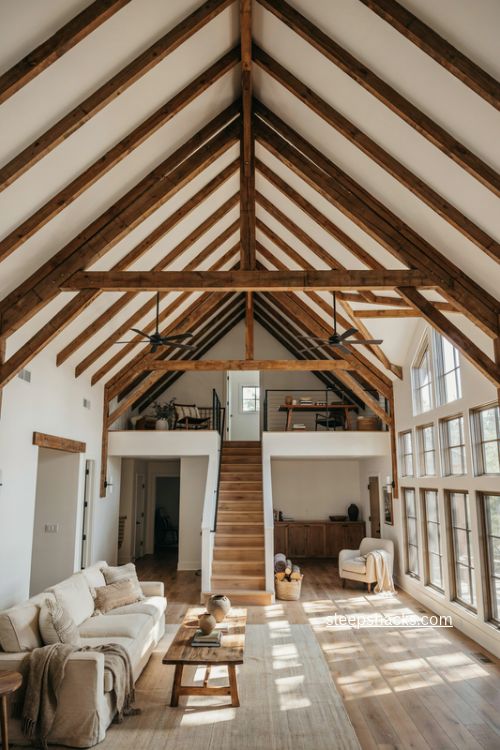loft barndominium floor plan with soaring ceilings exposed beams and tall windows 
