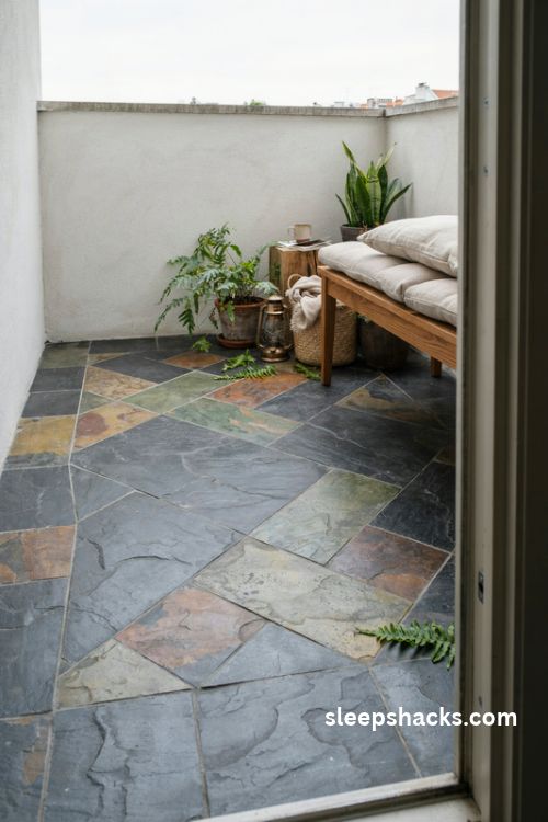 natural slate balcony floor tiles with earthy colors and lush greenery