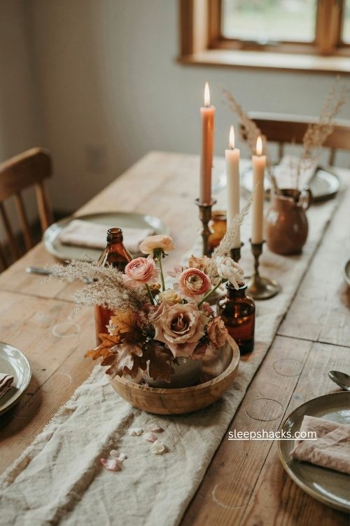 rustic fall floral centerpiece with blush peach flowers dried grasses and brown foliage 