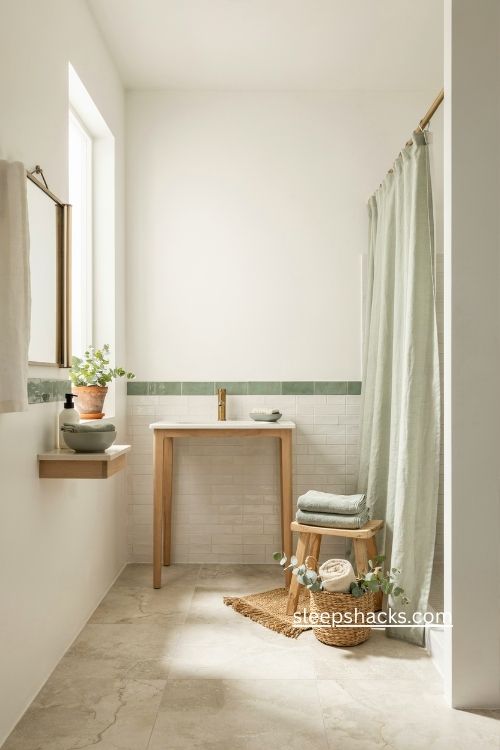 white bathroom with sage green accents and neutral decor 