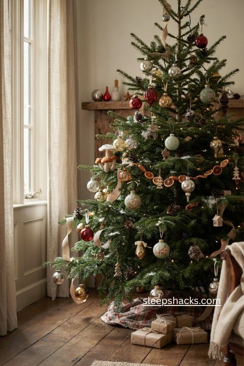 woodsy christmas tree with vintage glass ornaments faded colors mercury glass and rustic charm 